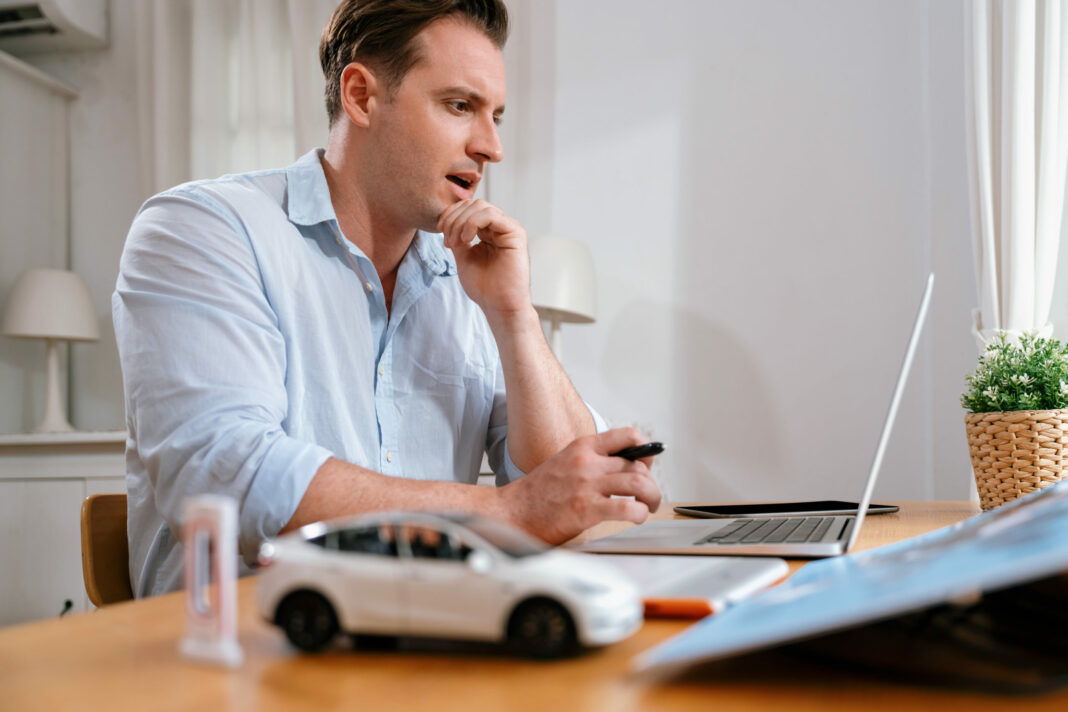 Car designer carefully analyzing car prototype. Synchronos